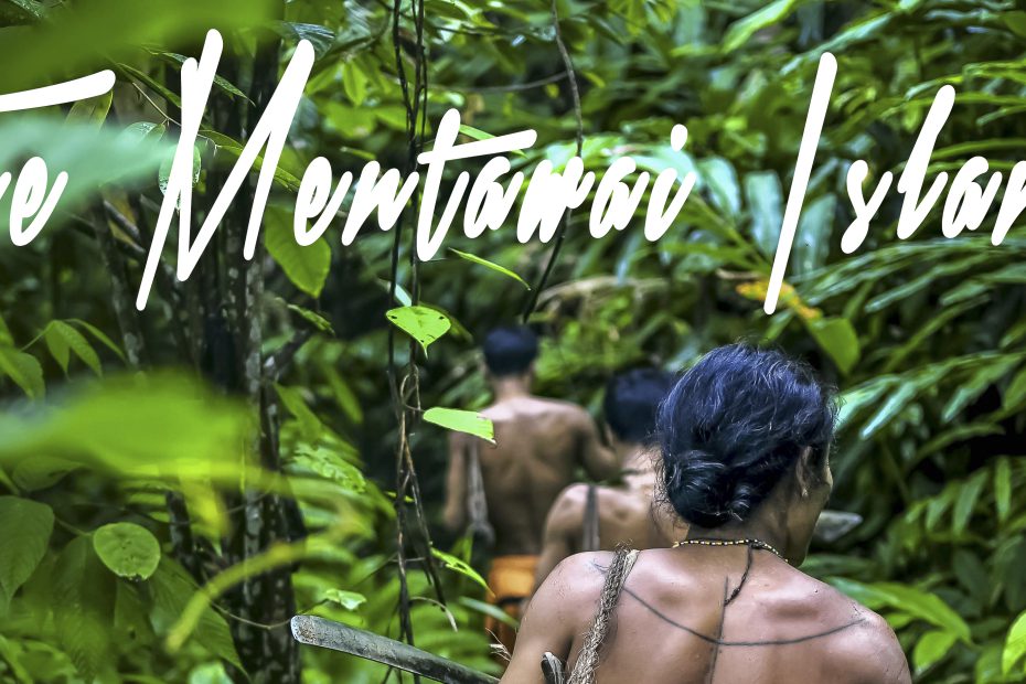 Two individuals trekking through a lush, green jungle environment with the text "Travel Blog: The Mentawai Islands" overlaying the image.